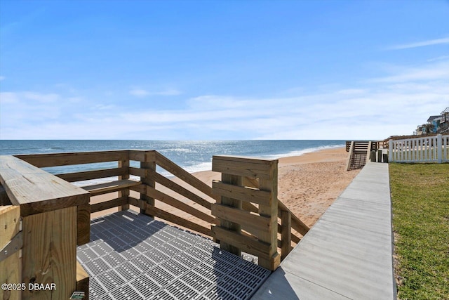 view of property's community featuring a beach view and a water view