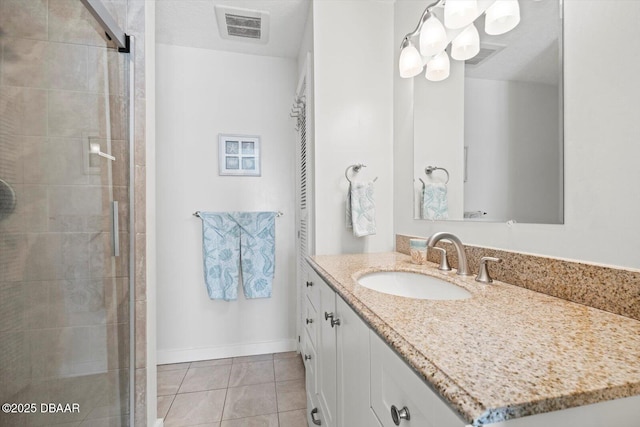 bathroom featuring vanity, tile patterned flooring, a textured ceiling, and walk in shower