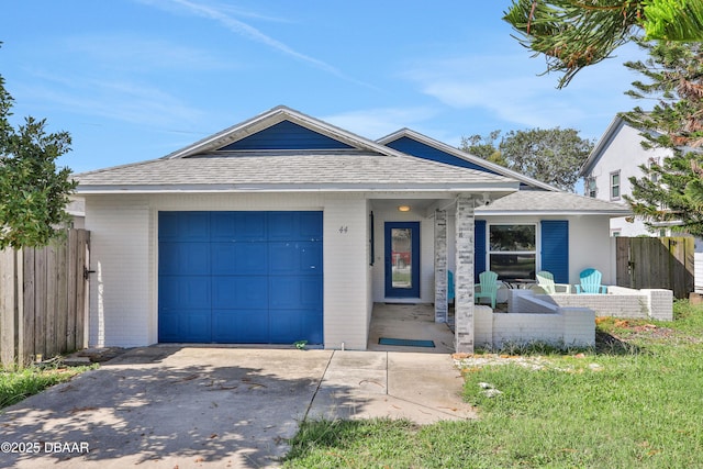 ranch-style home featuring a garage, driveway, roof with shingles, and fence