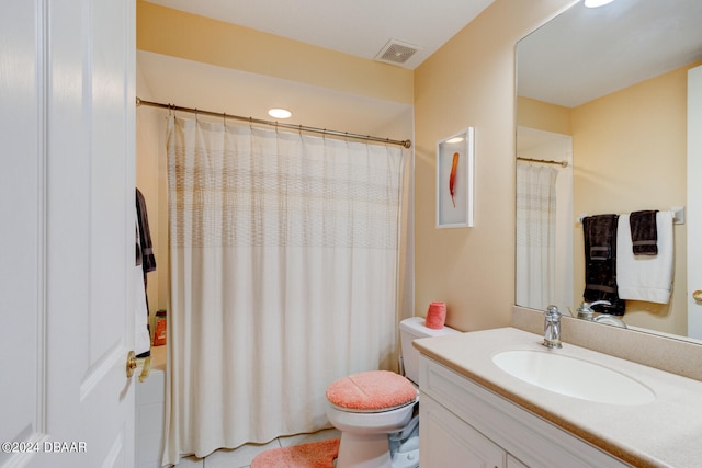 bathroom featuring toilet and vanity