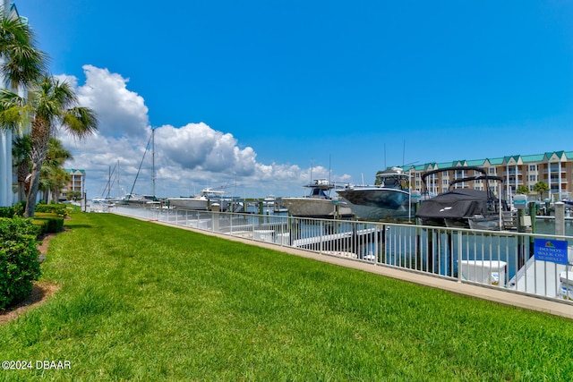 dock area featuring a water view and a lawn