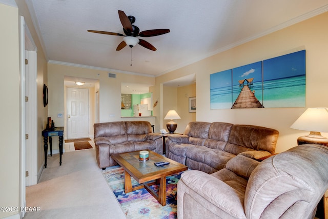 carpeted living room featuring ceiling fan and crown molding