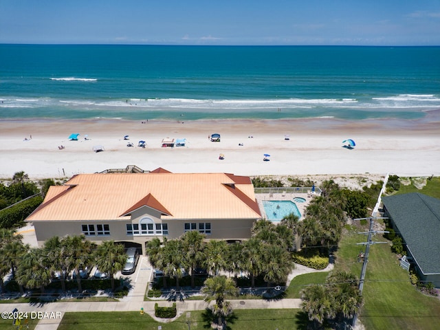 drone / aerial view featuring a beach view and a water view