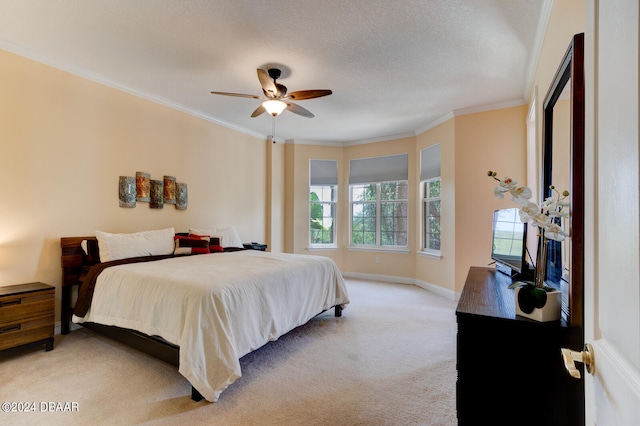 carpeted bedroom with ornamental molding, a textured ceiling, and ceiling fan