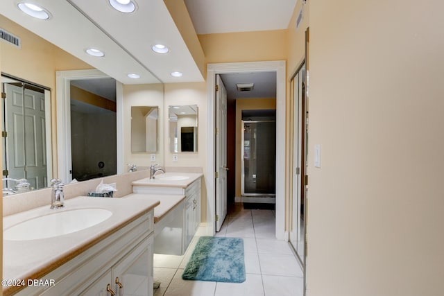 bathroom featuring walk in shower, vanity, and tile patterned floors