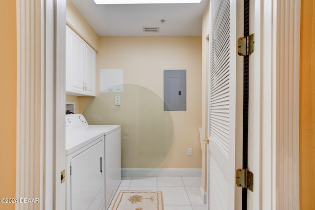 laundry area with electric panel, cabinets, light tile patterned floors, and separate washer and dryer