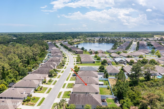 bird's eye view with a residential view, a water view, and a wooded view