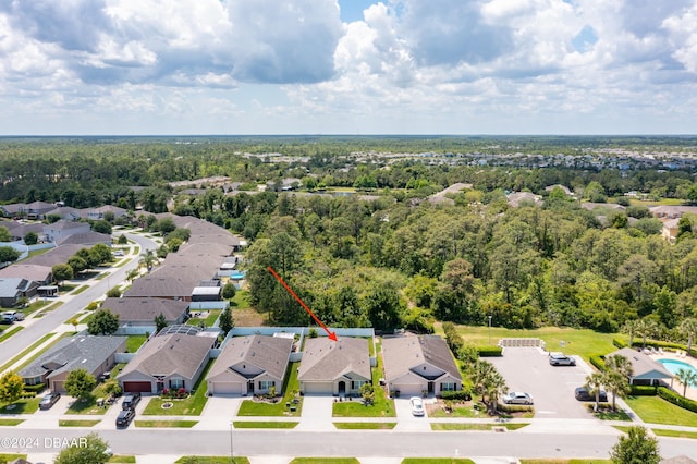 birds eye view of property with a view of trees and a residential view