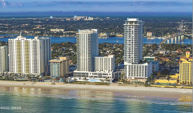 view of city featuring a beach view and a water view