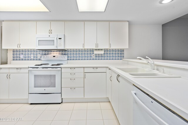 kitchen featuring white cabinets, tasteful backsplash, sink, and white appliances