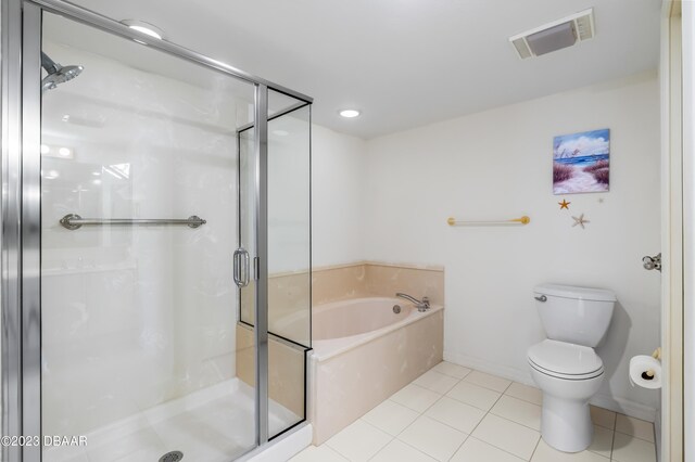 bathroom featuring toilet, tile patterned flooring, and separate shower and tub