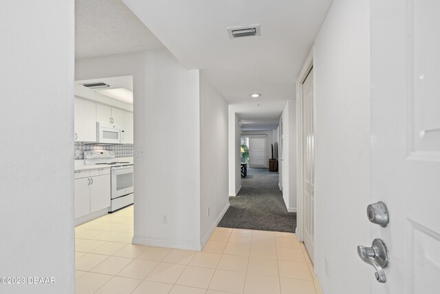 corridor featuring light tile patterned floors