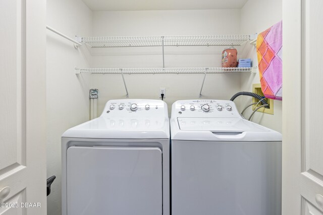 clothes washing area with independent washer and dryer