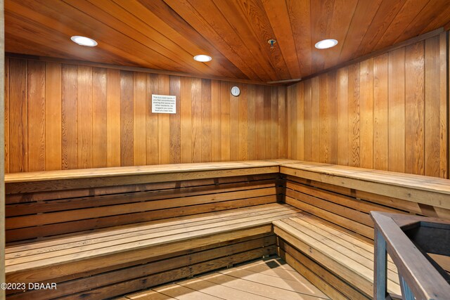 view of sauna / steam room with hardwood / wood-style floors, wooden walls, and wooden ceiling