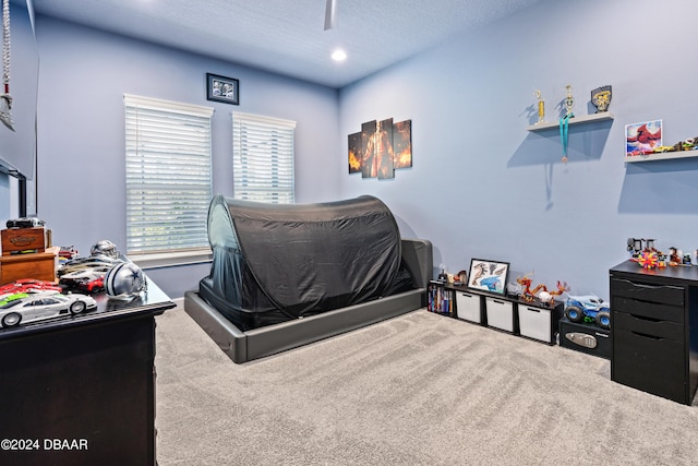 bedroom featuring carpet and a textured ceiling