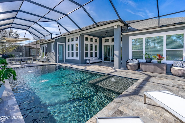 view of pool featuring pool water feature, ceiling fan, a patio area, and glass enclosure