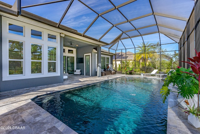 view of swimming pool featuring a lanai, ceiling fan, and a patio