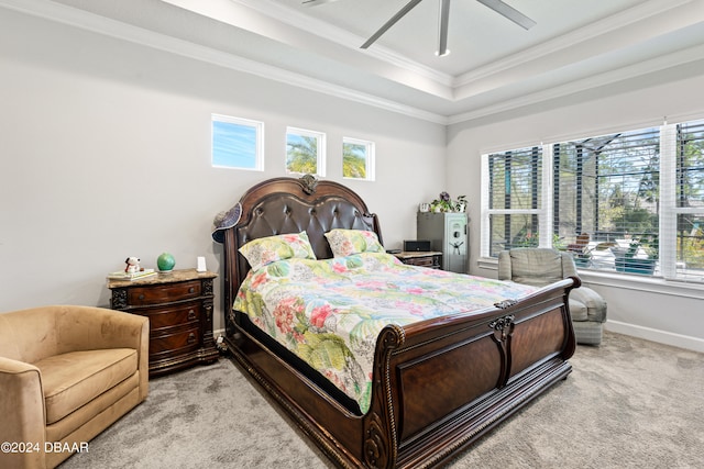 bedroom featuring a raised ceiling, ceiling fan, light colored carpet, and ornamental molding