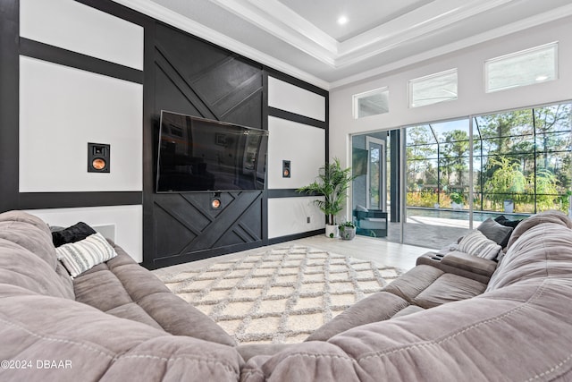 living room with a towering ceiling and crown molding