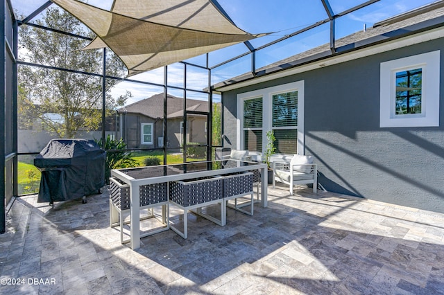 view of patio / terrace featuring glass enclosure and area for grilling