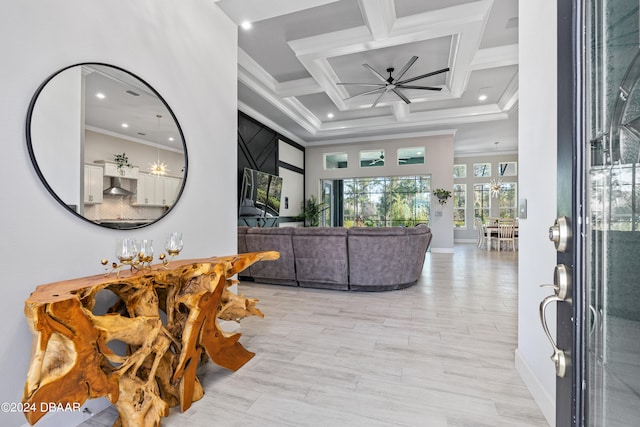 foyer entrance with coffered ceiling, ceiling fan, light wood-type flooring, ornamental molding, and beamed ceiling