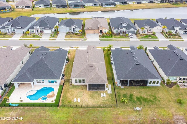 birds eye view of property with a residential view and a water view