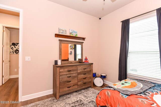 bedroom featuring baseboards and light wood finished floors