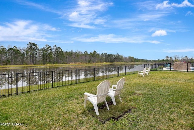 view of yard featuring a water view and fence