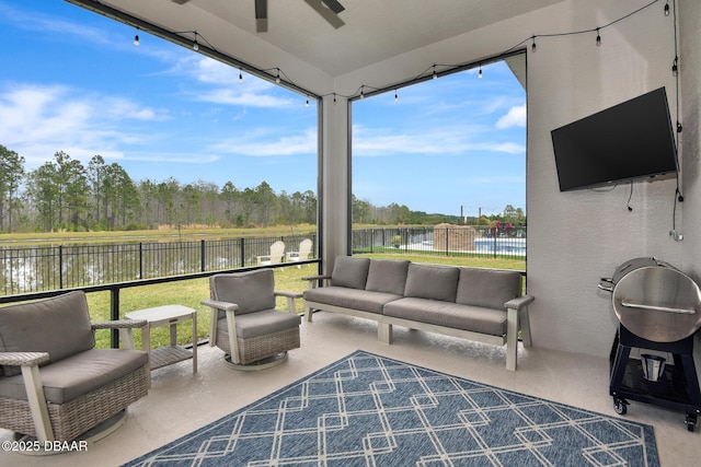 sunroom with a ceiling fan