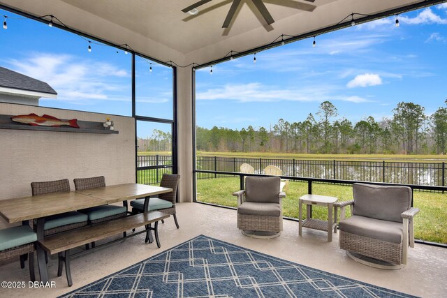 sunroom featuring ceiling fan