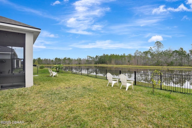 view of yard with fence and a water view