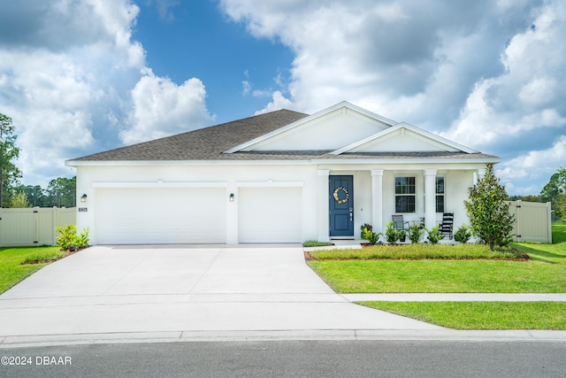 view of front of home with a garage and a front lawn