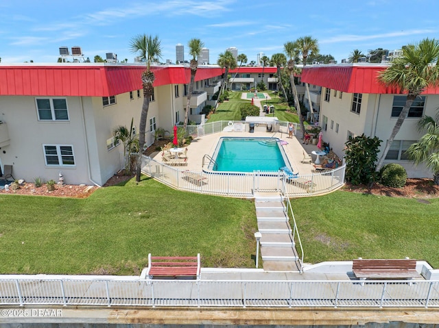 view of swimming pool with a patio and a lawn