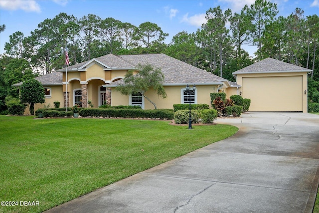 view of front facade with a garage and a front yard