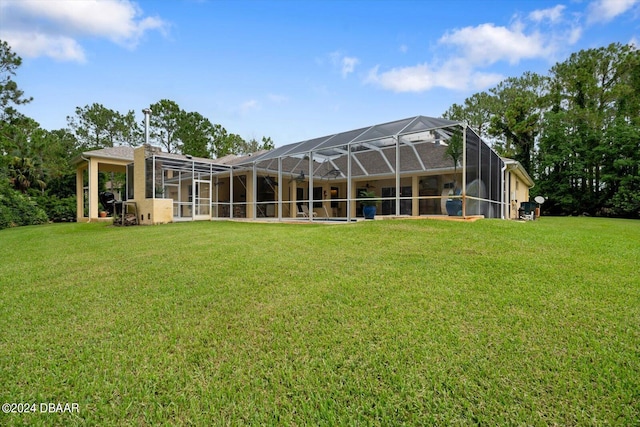 back of property with a lanai and a lawn