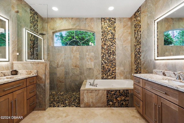 bathroom with tile walls, vanity, and separate shower and tub