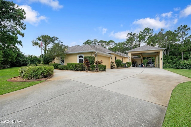 ranch-style home featuring a garage, a front lawn, and a carport