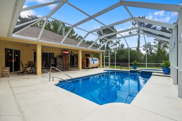 view of swimming pool featuring a lanai, a patio area, and ceiling fan