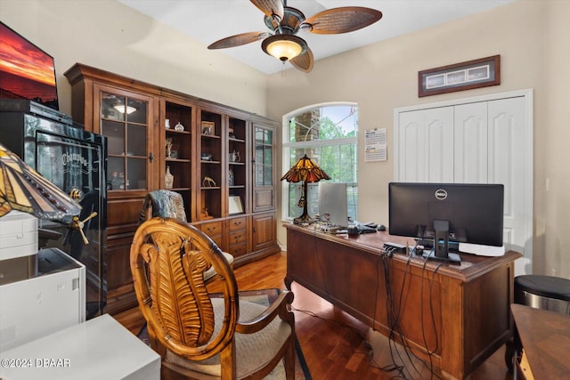 office area with dark wood-type flooring and ceiling fan