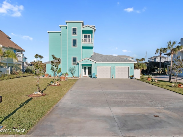 view of front of house featuring a balcony, french doors, and a front lawn