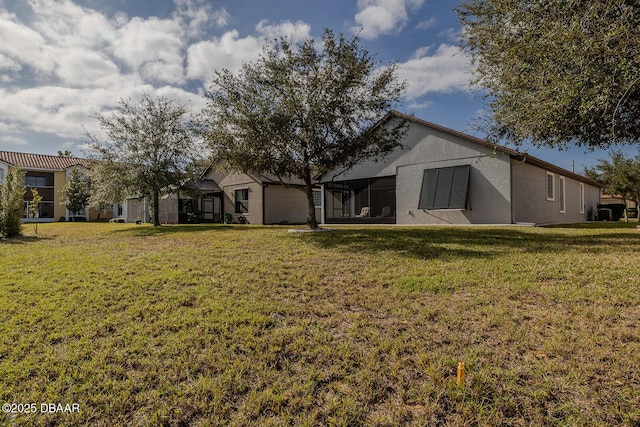 rear view of house featuring a lawn