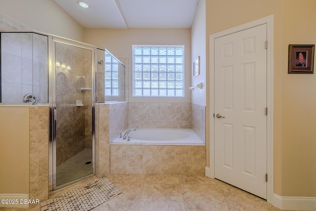 bathroom with separate shower and tub and tile patterned floors