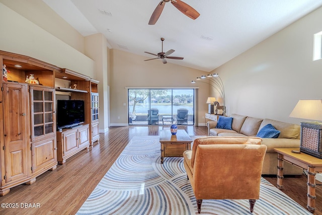 living room featuring high vaulted ceiling, light wood-type flooring, and ceiling fan