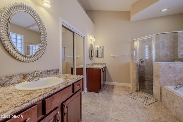 bathroom with tile patterned floors, vanity, and shower with separate bathtub