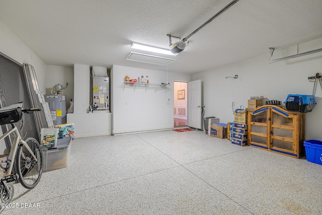 garage featuring water heater, a garage door opener, and heating unit