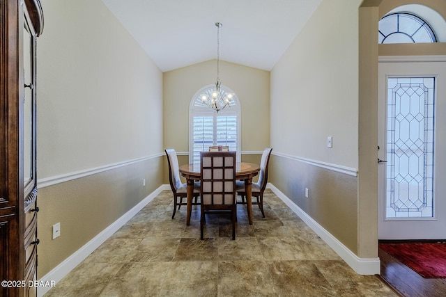 dining area featuring vaulted ceiling and a chandelier