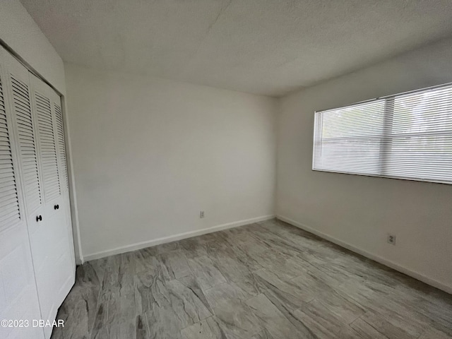 1504 Virginia Ave Unit 112, Daytona Beach, FL 32114 - unfurnished bedroom with a closet and baseboards