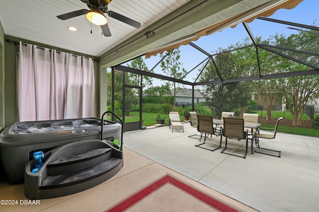 view of patio with ceiling fan, a lanai, and a hot tub