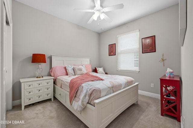 bedroom featuring light carpet and ceiling fan