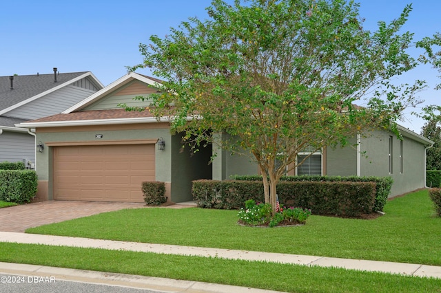 view of front facade with a garage and a front lawn